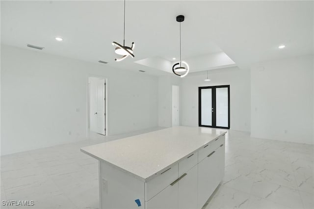 472 Rajah St, Lehigh Acres, FL 33974 - kitchen with open floor plan, a raised ceiling, light marble finish flooring, a center island, and recessed lighting