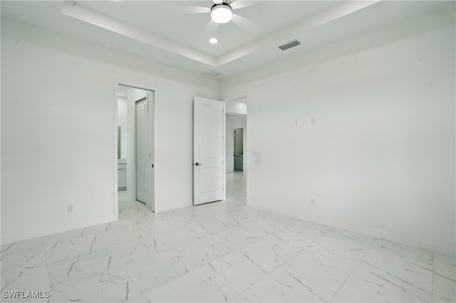 472 Rajah St, Lehigh Acres, FL 33974 - unfurnished room featuring ceiling fan, a tray ceiling, recessed lighting, and light marble finish flooring