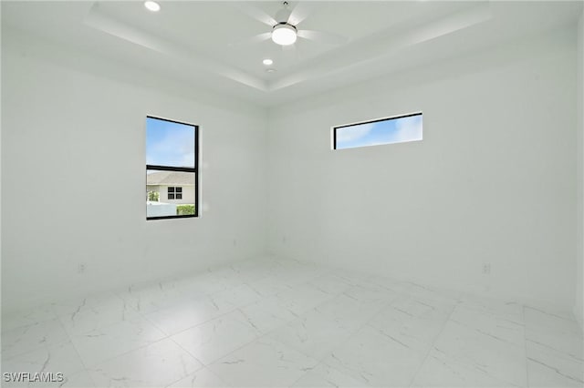 472 Rajah St, Lehigh Acres, FL 33974 - empty room with a tray ceiling, recessed lighting, marble finish floors, and ceiling fan