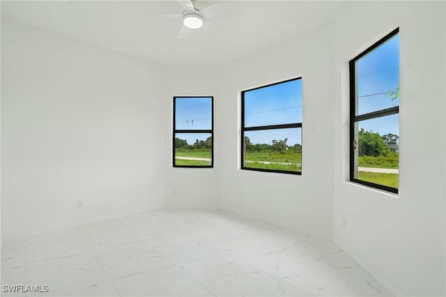472 Rajah St, Lehigh Acres, FL 33974 - spare room with marble look tile flooring and a ceiling fan