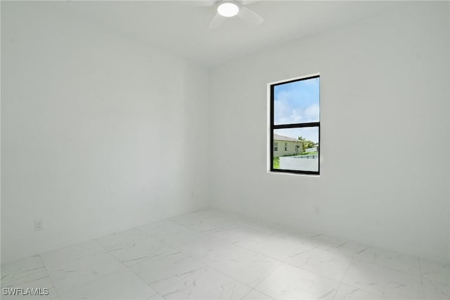 472 Rajah St, Lehigh Acres, FL 33974 - spare room with marble look tile flooring and a ceiling fan