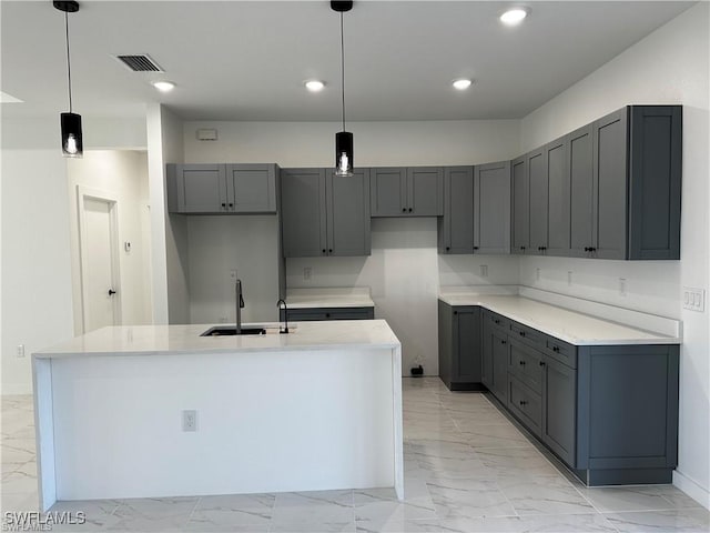 394 Palora Ave, Lehigh Acres, FL 33974 - kitchen featuring light marble finish flooring, gray cabinets, a center island with sink, and recessed lighting