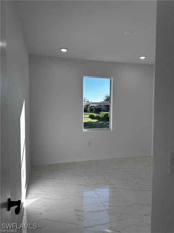 394 Palora Ave, Lehigh Acres, FL 33974 - unfurnished room featuring recessed lighting and marble finish floors