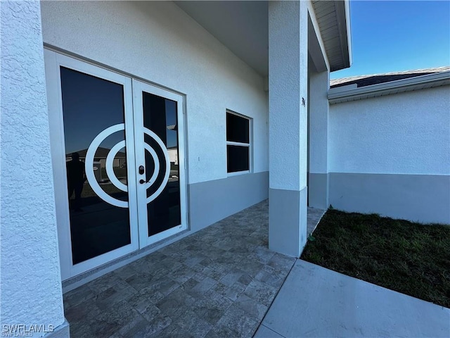 394 Palora Ave, Lehigh Acres, FL 33974 - property entrance with french doors, stucco siding, and a patio