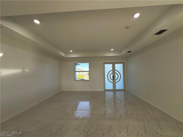 394 Palora Ave, Lehigh Acres, FL 33974 - spare room with recessed lighting, a raised ceiling, light marble finish floors, and french doors