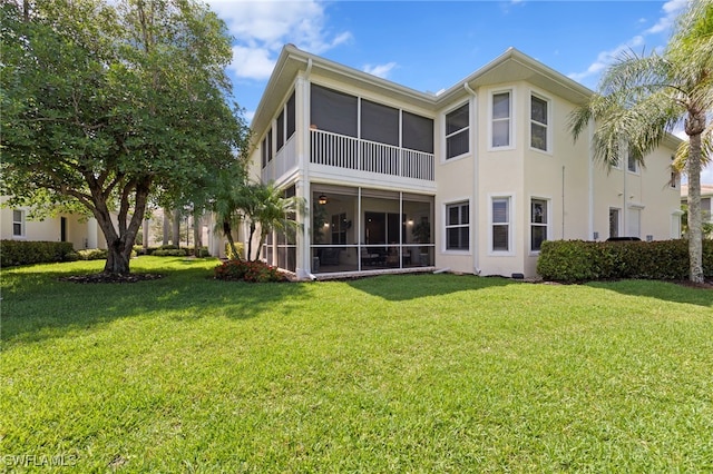 28649 San Lucas Ln Unit 102, Bonita Springs, FL 34135 - rear view of house featuring a sunroom, a lawn, and stucco siding