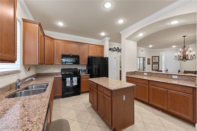 28649 San Lucas Ln Unit 102, Bonita Springs, FL 34135 - kitchen featuring black appliances, brown cabinets, ornamental molding, a center island, and light tile patterned floors