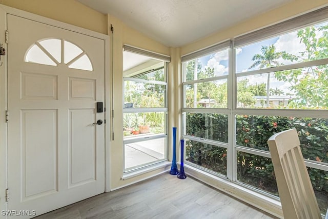 1413 Davis Dr, Fort Myers, FL 33919 - unfurnished sunroom with plenty of natural light and wood finished floors