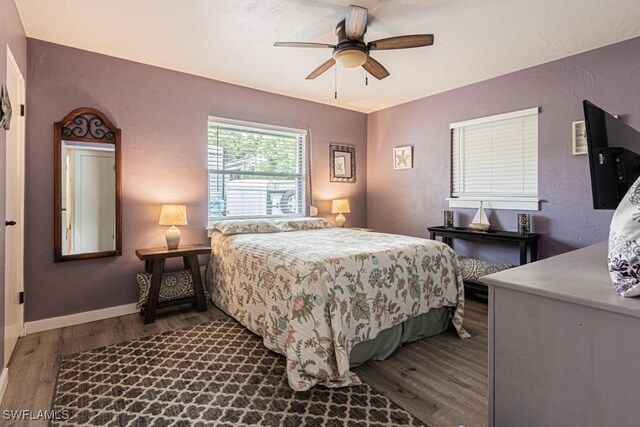 1413 Davis Dr, Fort Myers, FL 33919 - bedroom featuring wood finished floors, a ceiling fan, and a textured wall