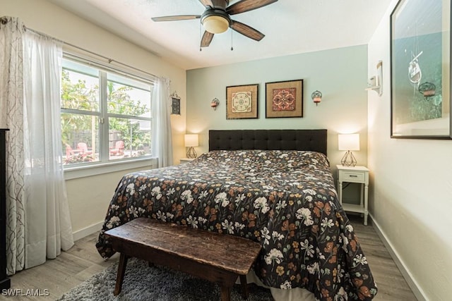 1413 Davis Dr, Fort Myers, FL 33919 - bedroom featuring wood finished floors and a ceiling fan