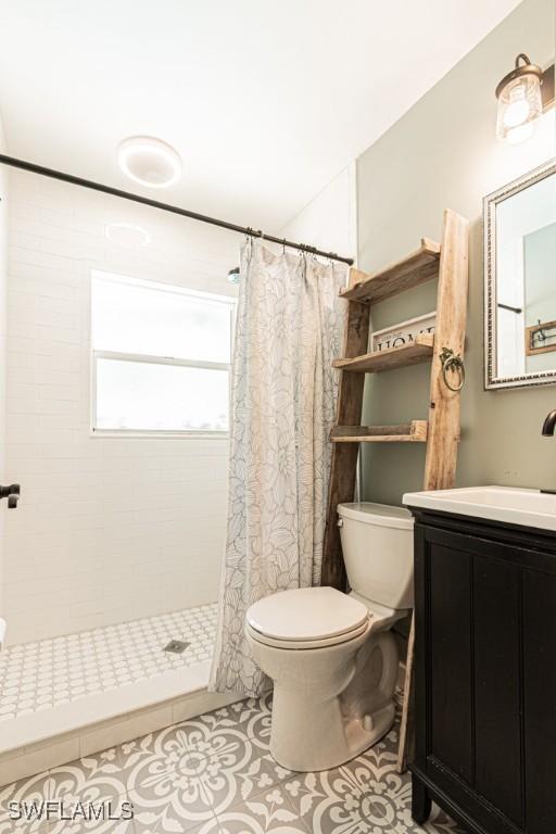 1413 Davis Dr, Fort Myers, FL 33919 - full bath featuring vanity, a tile shower, and tile patterned flooring