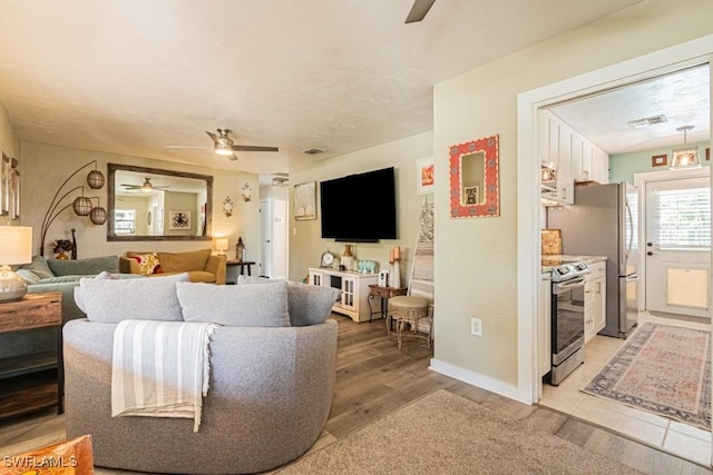 1413 Davis Dr, Fort Myers, FL 33919 - living area featuring ceiling fan and light wood-type flooring