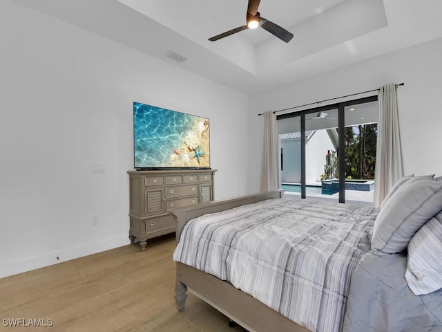 3475 3rd Ave SW, Naples, FL 34117 - bedroom with access to outside, a tray ceiling, light wood-style floors, and a ceiling fan