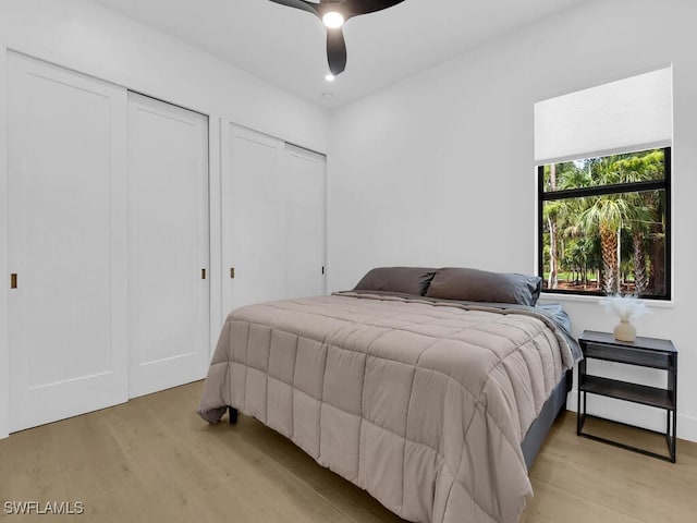 3475 3rd Ave SW, Naples, FL 34117 - bedroom featuring light wood-style floors, multiple closets, and ceiling fan