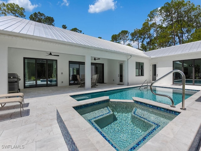 3475 3rd Ave SW, Naples, FL 34117 - view of swimming pool with ceiling fan, area for grilling, a patio area, and a pool with connected hot tub