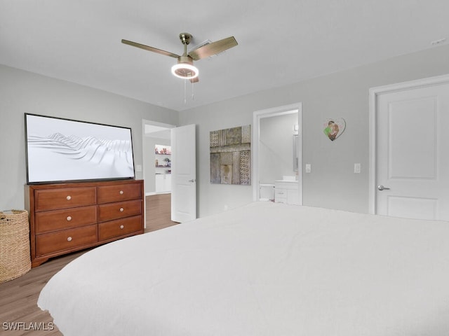 3475 3rd Ave SW, Naples, FL 34117 - bedroom featuring wood finished floors, a ceiling fan, and ensuite bath
