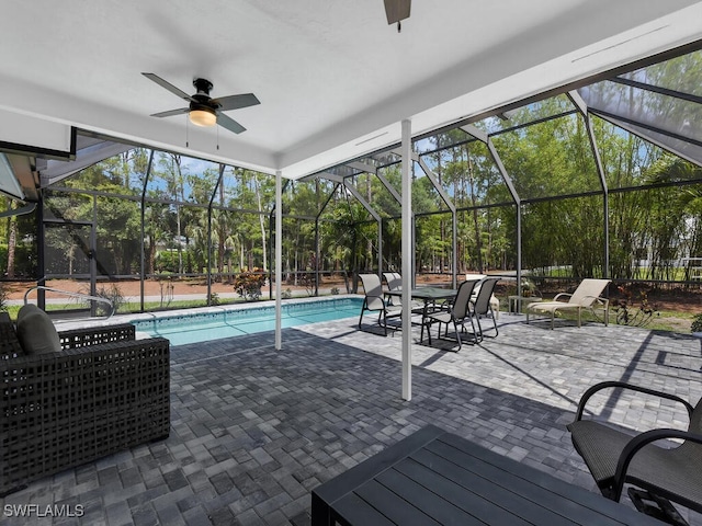 3475 3rd Ave SW, Naples, FL 34117 - swimming pool featuring a ceiling fan, view of wooded area, a patio area, and glass enclosure