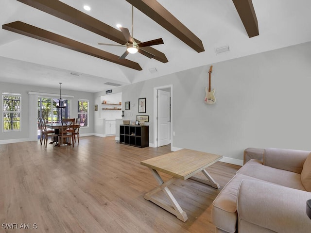 3475 3rd Ave SW, Naples, FL 34117 - living room with a ceiling fan, light wood-style floors, and a chandelier