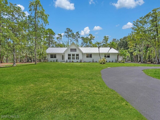 3475 3rd Ave SW, Naples, FL 34117 - single story home with a front lawn, a metal roof, and asphalt driveway