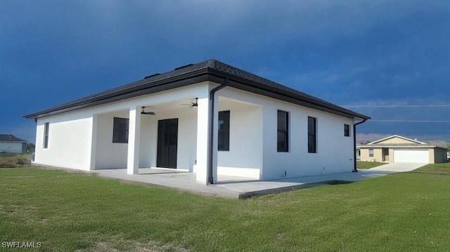 1024 Halby Ave S, Lehigh Acres, FL 33974 - back of property with a yard, stucco siding, ceiling fan, and a patio