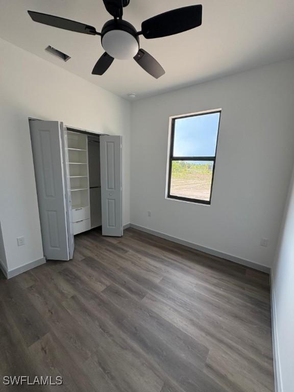 1024 Halby Ave S, Lehigh Acres, FL 33974 - unfurnished bedroom with wood finished floors, a closet, and a ceiling fan