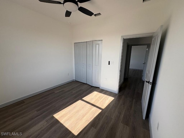 1024 Halby Ave S, Lehigh Acres, FL 33974 - unfurnished bedroom featuring dark wood-style flooring, a closet, and a ceiling fan