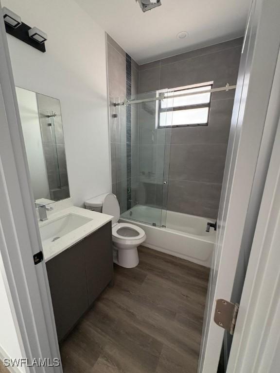 1024 Halby Ave S, Lehigh Acres, FL 33974 - bathroom with vanity, enclosed tub / shower combo, and wood finished floors