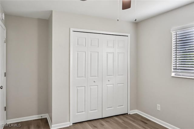 740 SW 5th St, Cape Coral, FL 33991 - unfurnished bedroom featuring wood finished floors, a closet, and a ceiling fan