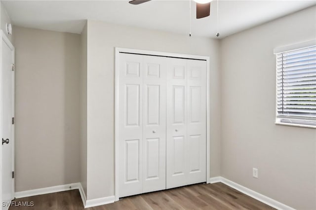 740 SW 5th St, Cape Coral, FL 33991 - unfurnished bedroom with wood finished floors, a closet, and a ceiling fan