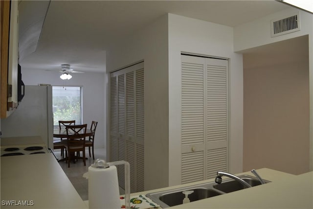 4241 Chantelle Dr Unit D102, Naples, FL 34112 - kitchen featuring ceiling fan, wood finished floors, and light countertops