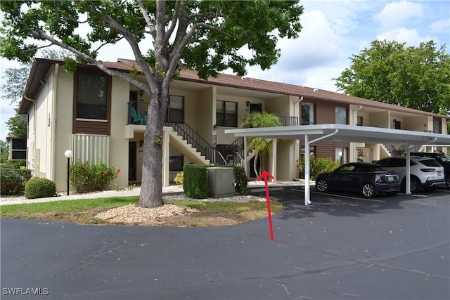 4241 Chantelle Dr Unit D102, Naples, FL 34112 - view of property with stairway and covered parking