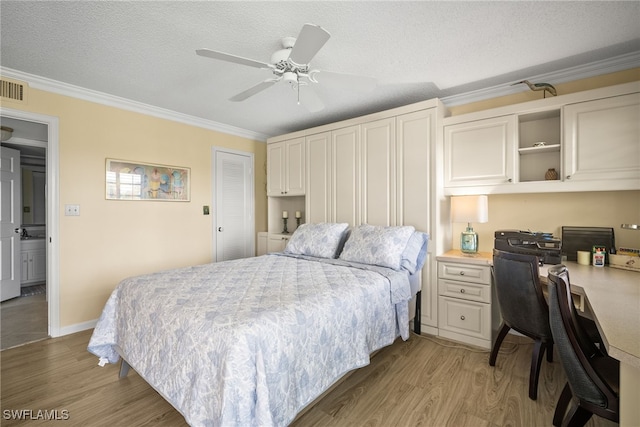 415 Augusta Blvd Unit 310, Naples, FL 34113 - bedroom with crown molding, light wood-style flooring, built in study area, a textured ceiling, and a ceiling fan