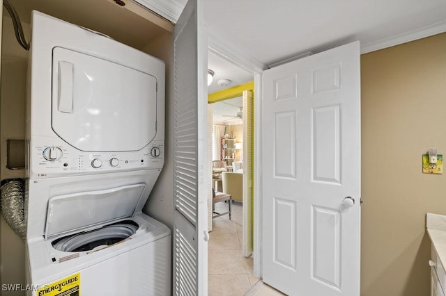 415 Augusta Blvd Unit 310, Naples, FL 34113 - laundry area with stacked washer and clothes dryer and light tile patterned flooring