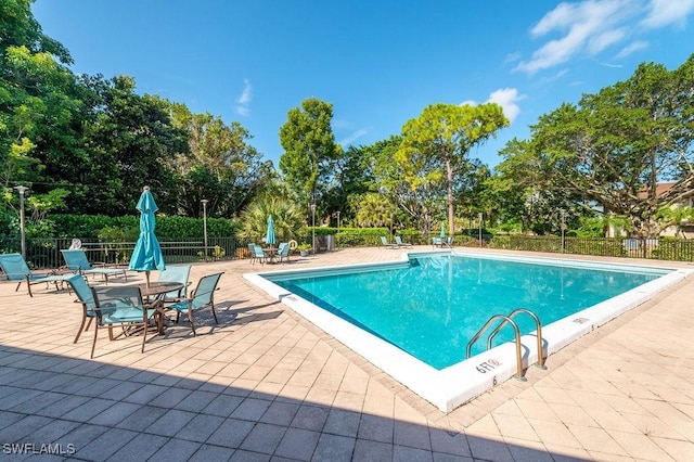 415 Augusta Blvd Unit 310, Naples, FL 34113 - community pool with a patio area and view of scattered trees