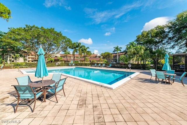 415 Augusta Blvd Unit 310, Naples, FL 34113 - community pool featuring a patio and outdoor dining area