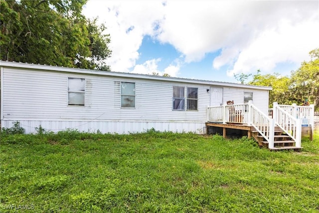 1798 Williams Rd, Moore Haven, FL 33471 - back of property with a lawn and a wooden deck