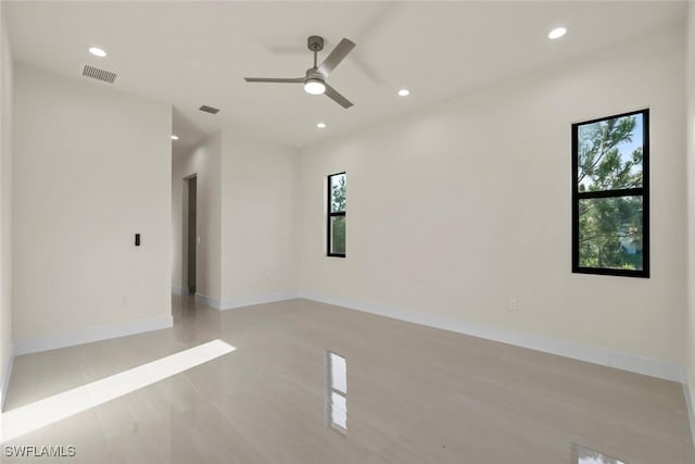 3115 41st St SW, Lehigh Acres, FL 33976 - spare room featuring healthy amount of natural light, recessed lighting, a ceiling fan, and light tile patterned floors