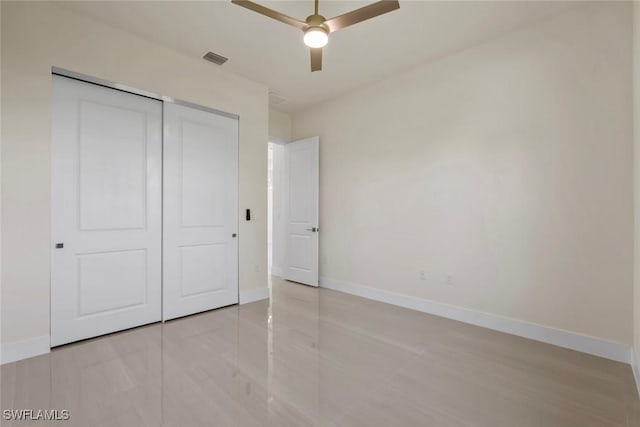 3115 41st St SW, Lehigh Acres, FL 33976 - unfurnished bedroom featuring a closet, ceiling fan, and light tile patterned floors