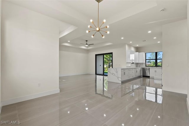 3115 41st St SW, Lehigh Acres, FL 33976 - unfurnished living room featuring a chandelier, light tile patterned floors, recessed lighting, a raised ceiling, and a ceiling fan