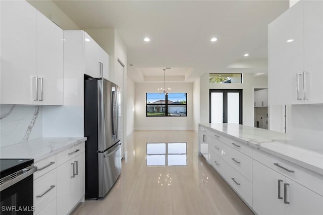 3115 41st St SW, Lehigh Acres, FL 33976 - kitchen featuring appliances with stainless steel finishes, white cabinetry, decorative backsplash, french doors, and recessed lighting