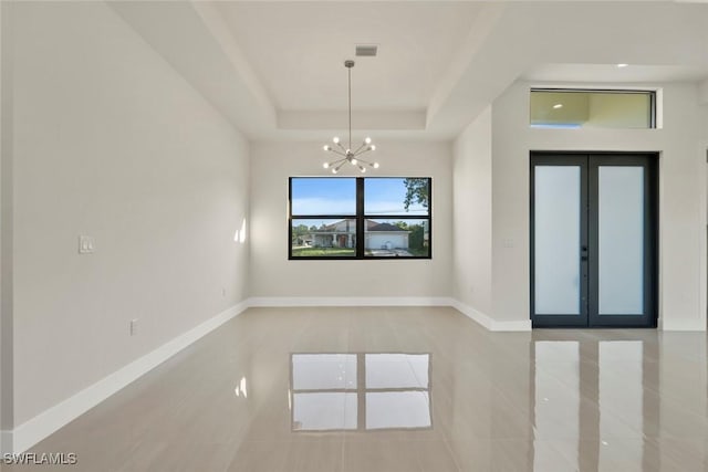 3115 41st St SW, Lehigh Acres, FL 33976 - spare room with tile patterned flooring, a chandelier, and a tray ceiling