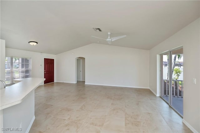 806 SW 4th Ave, Cape Coral, FL 33991 - unfurnished living room featuring a ceiling fan, lofted ceiling, healthy amount of natural light, and arched walkways