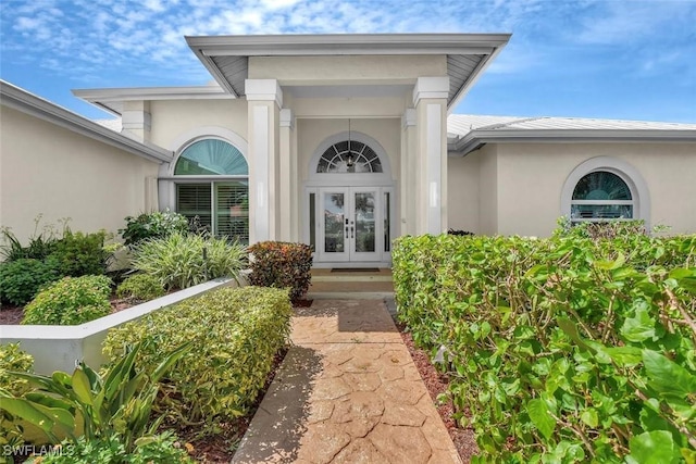 2546 SW 45th St, Cape Coral, FL 33914 - doorway to property with french doors and stucco siding