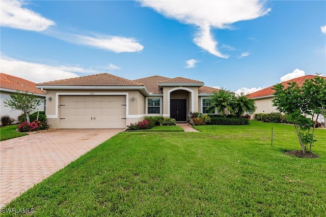 3260 Magnolia Landing Ln, North Fort Myers, FL 33917 - mediterranean / spanish-style house featuring decorative driveway, stucco siding, a garage, a tile roof, and a front lawn