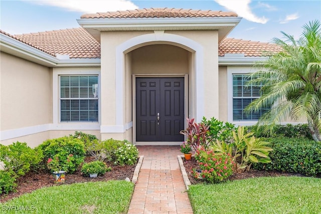 3260 Magnolia Landing Ln, North Fort Myers, FL 33917 - doorway to property featuring a tiled roof and stucco siding