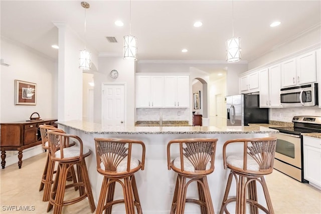 3260 Magnolia Landing Ln, North Fort Myers, FL 33917 - kitchen featuring stainless steel appliances, ornamental molding, backsplash, recessed lighting, and white cabinetry