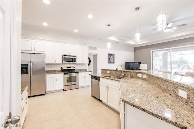 3260 Magnolia Landing Ln, North Fort Myers, FL 33917 - kitchen with appliances with stainless steel finishes, white cabinetry, pendant lighting, a raised ceiling, and recessed lighting