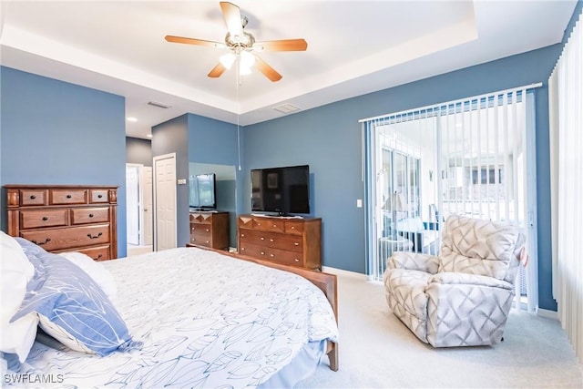 3260 Magnolia Landing Ln, North Fort Myers, FL 33917 - carpeted bedroom with a tray ceiling, access to exterior, and ceiling fan