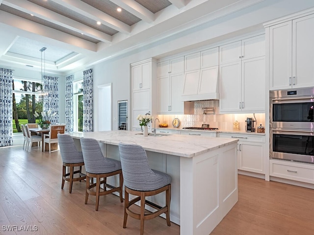 130 Burning Tree Dr, Naples, FL 34105 - kitchen featuring appliances with stainless steel finishes, light wood-style floors, tasteful backsplash, white cabinetry, and recessed lighting