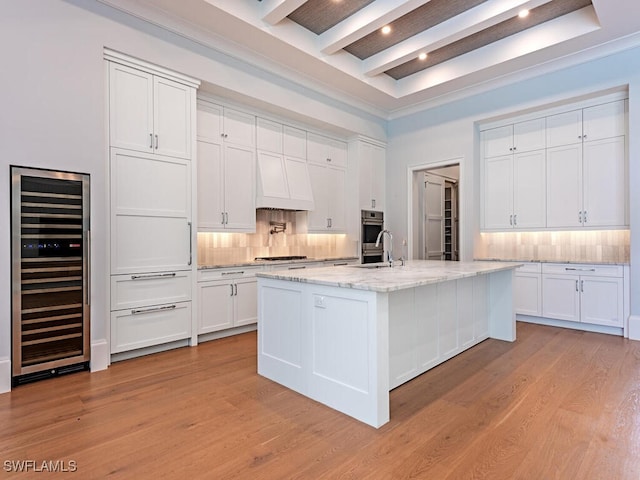 130 Burning Tree Dr, Naples, FL 34105 - kitchen with wine cooler, backsplash, beam ceiling, light wood-style flooring, and white cabinetry